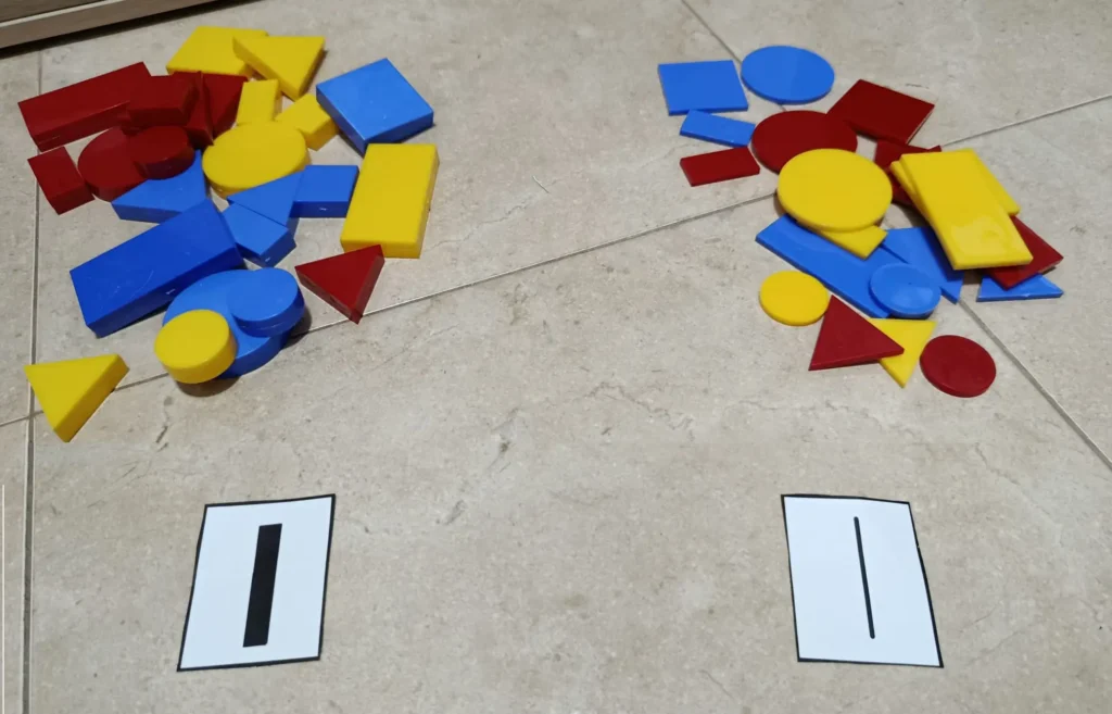 Juego de ordenación de bloques lógicos en el que organizamos las piezas en función de su grosor (gruesas y delgadas) separándolas con cartulinas indicadoras de grosor